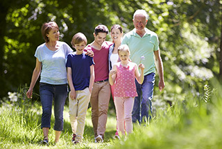 family walking for wellbeing - improves risk of hearing loss