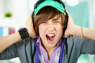 teenager damaging ears with loud music
