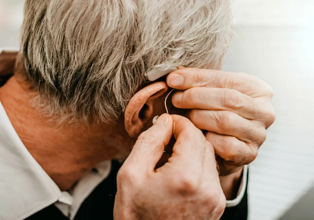 man putting in hearing aid