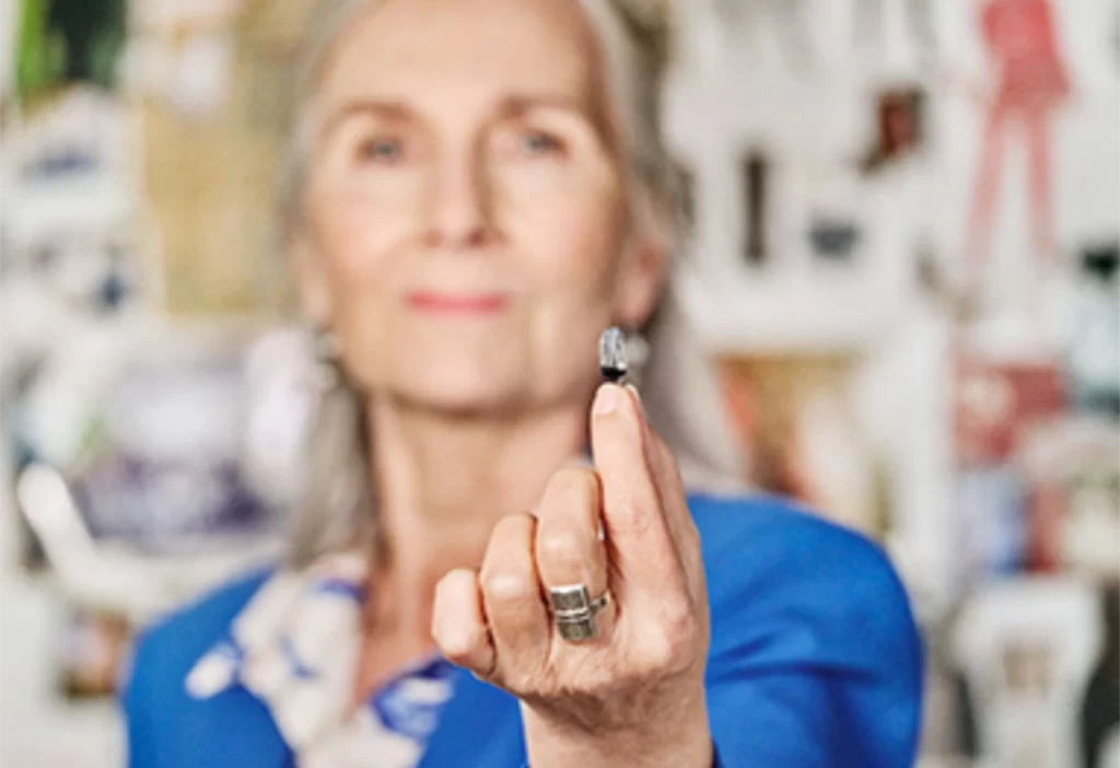 small hearing aid in womans hand