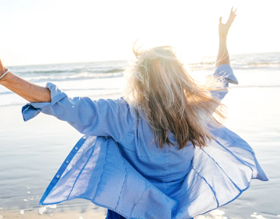 Woman at beach-Protect Your Hearing Aids During An Australian Summer